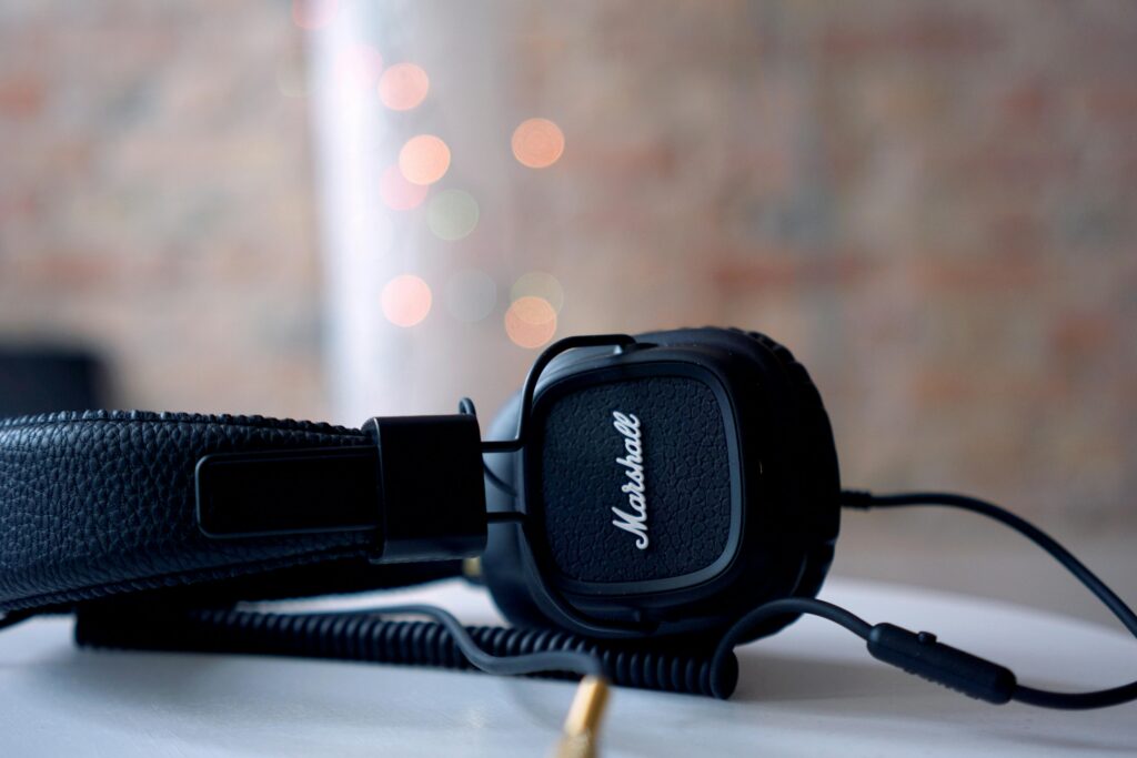 High-quality black headphones on a table with bokeh lights background, perfect for music lovers.